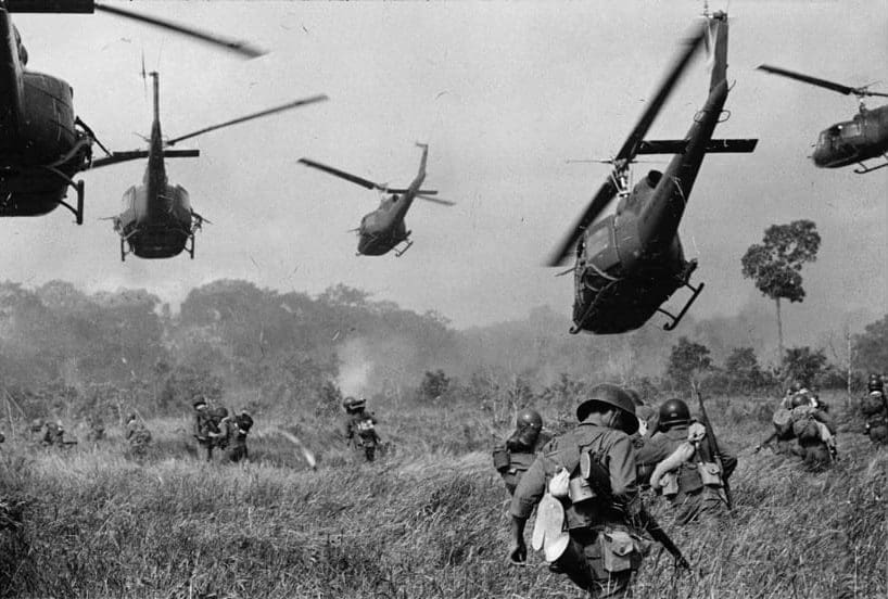 Hovering U.S. Army helicopters pour machine gun fire into the tree line to cover the advance of South Vietnamese ground troops in an attack on a Viet Cong camp 18 miles north of Tay Ninh, northwest of Saigon near the Cambodian border, in March 1965 during the Vietnam War.  (AP Photo/Horst Faas)